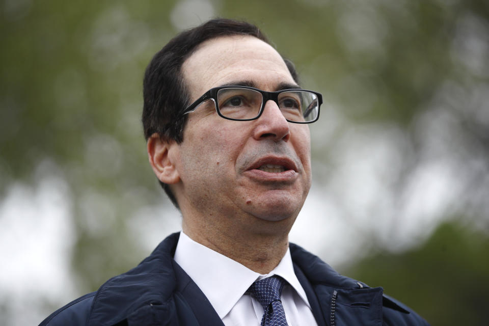 Treasury Secretary Steve Mnuchin speaks with reporters about economic impacts of the coronavirus outside the White House, Sunday, March 29, 2020, in Washington. (AP Photo/Patrick Semansky)