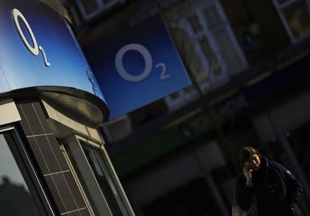 A woman speaks on her mobile telephone outside an O2 shop in Loughborough, central England January 23, 2015. REUTERS/Darren Staples