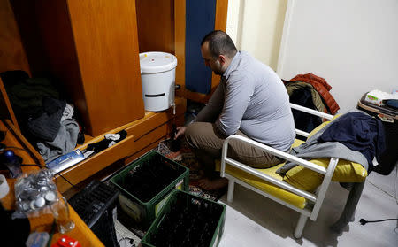 Onder Ceyhan, a 25-year old university student, fills a bottle as he brews his own beer at his home in Ankara, Turkey, November 6, 2017. REUTERS/Umit Bektas