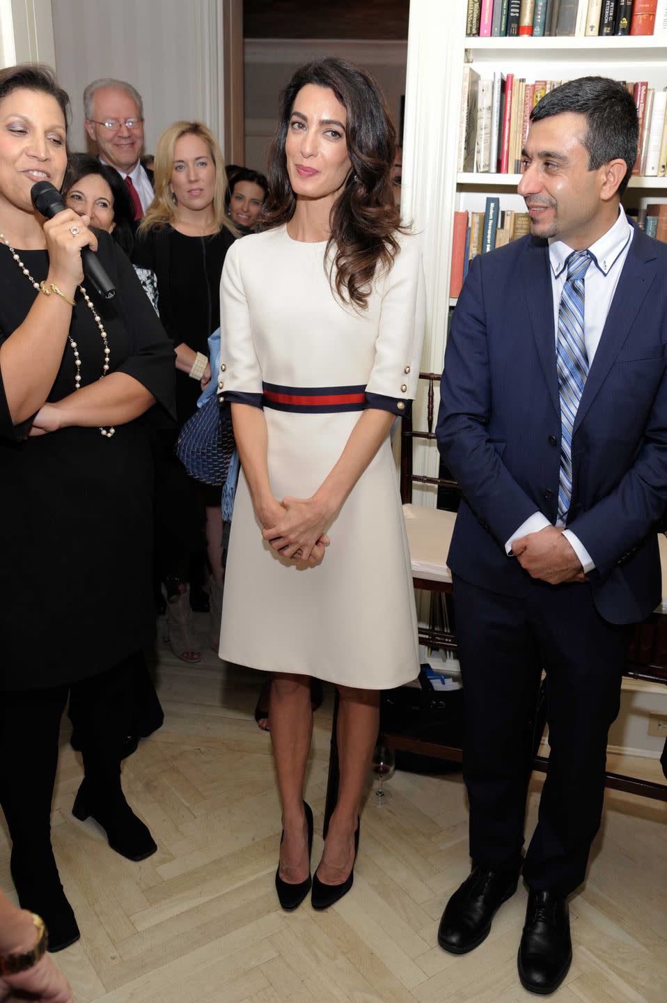 <p>Amal attends the Women In The World reception hosted by the U.N. wearing a knee-length dress accented with a red and blue belt.</p>