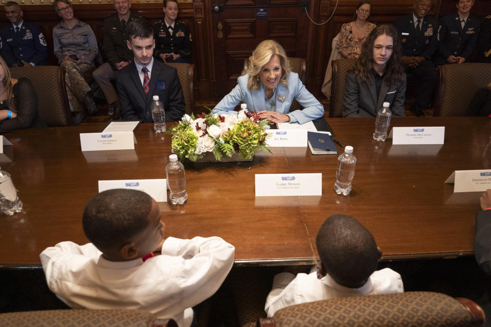 First lady Jill Biden, center, speaks with Jaxson Mondy, front left, and his brother Larry Mondy, of the U.S. Virgin Islands, while she meets with children of National Guard members, inside the Eisenhower Executive Office Building on the White House complex, Monday, Nov. 27, 2023, in Washington. At left of Biden is Caleb Grieco, of New Jersey, and right is Hudson McCaslin, of Tennessee. (AP Photo/Jacquelyn Martin)