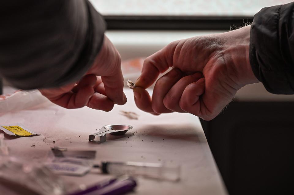 A drug user prepares heroin before injecting inside of a Safe Consumption van on September 25, 2020 in Glasgow, Scotland.