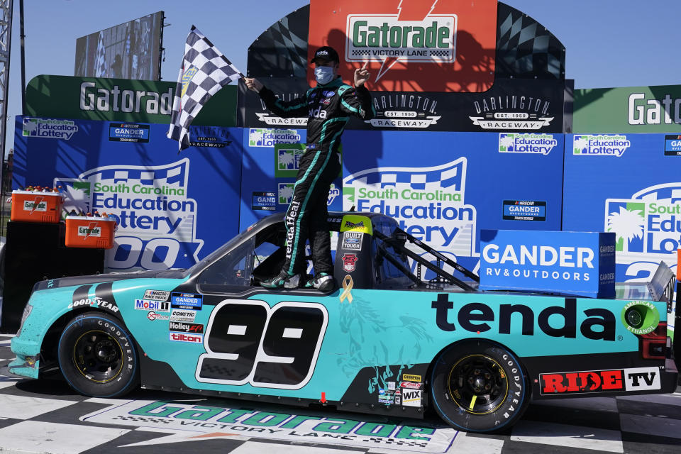 Ben Rhodes (99) celebrates after a win after a NASCAR Truck race Sunday, Sept. 6, 2020, in Darlington, S.C. (AP Photo/Chris Carlson)