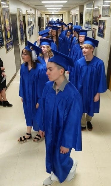 Central High School seniors wait their turn to enter Golden Eagles Arena at the onset of Sunday afternoon's graduation certemony.