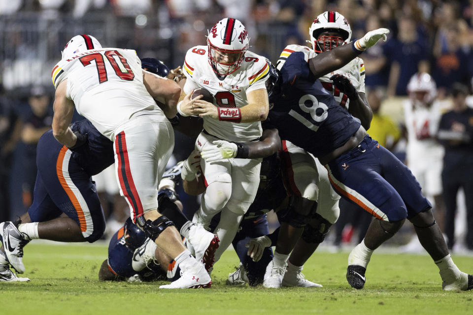 Maryland quarterback Billy Edwards Jr. (9) drives with the ball against Virginia during the second half of an NCAA college football game, Saturday, Sept. 14, 2024, in Charlottesville, Va. (AP Photo/Mike Kropf)