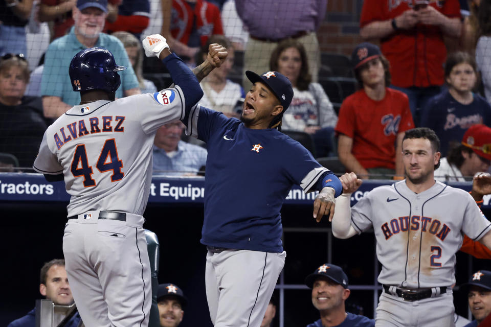 Houston Astros' Yordan Alvarez (44) celebrates with teammates after hitting a two-run home run against the Atlanta Braves during the ninth inning of a baseball game Friday, April 21, 2023, in Atlanta. (AP Photo/Butch Dill)