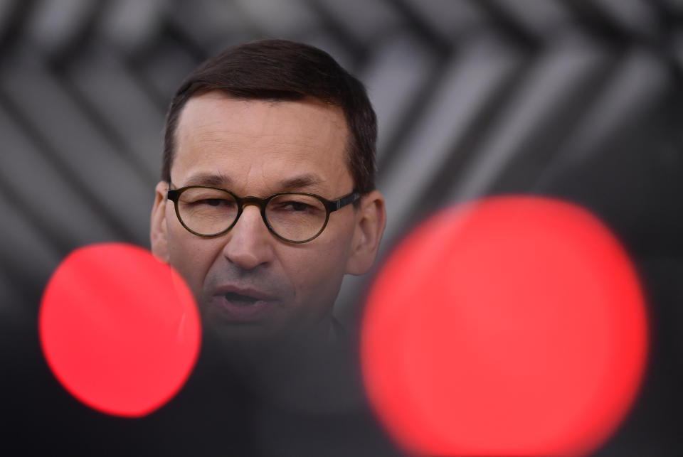 Poland's Prime Minister Mateusz Morawiecki speaks as he arrives for an EU summit at the European Council building in Brussels, Thursday, Dec. 10, 2020. European Union leaders meet for a year-end summit that will address anything from climate, sanctions against Turkey to budget and virus recovery plans. Brexit will be discussed on the sidelines. (John Thys, Pool via AP)