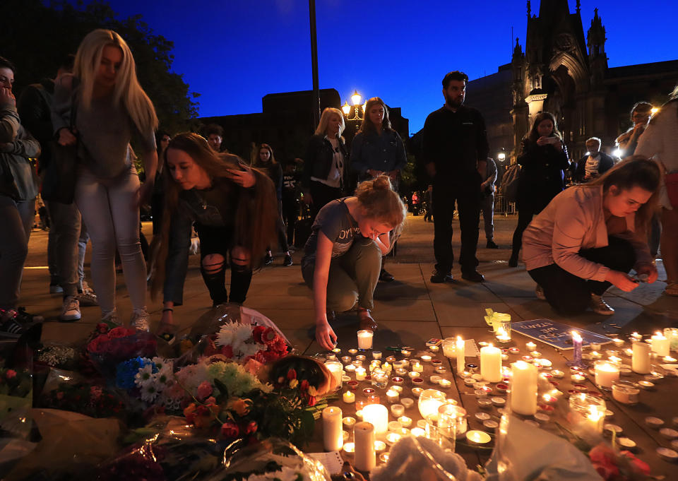 People leave tributes to victims of the Manchester attack in Albert Square, Manchester.