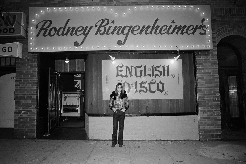 LOS ANGELES - CIRCA 1974:  Nightclub owner Rodney Bingenheimer stands outside his English Disco located at 7561 Sunset Boulevard on the Sunset Strip circa 1974  in Los Angeles, California. (Photo by Richard Creamer/ Michael Ochs Archives/Getty Images)
