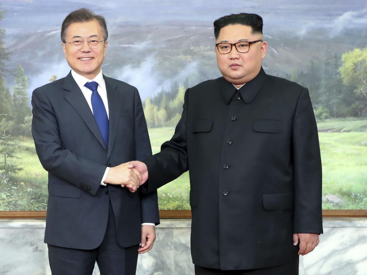 South Korea’s Moon Jae-in meets Kim Jong-un at the border city of Panmunjom in May – Kim has reaffirmed a commitment to denuclearisation and working with Washington: AP