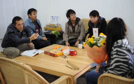 Supporters of Chinese artist Ai Weiwei wait for him to arrive at his studio in Beijing on November 9, 2011. Since Friday, supporters have been sending Ai money through Internet and bank transfers, while some have even resorted to throwing cash over the walls into his courtyard home