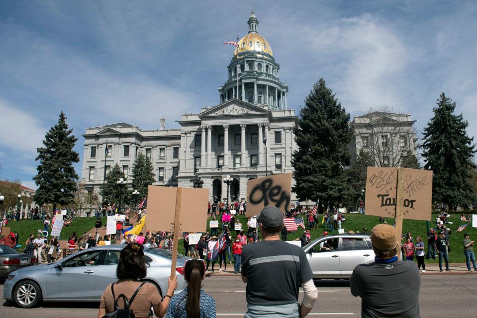 Demonstrators gather in front of the Colorado State Capitol building in Denver, Colorado.