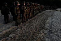 Recruits line up before field exercises during their 16-day basic training for Poland's Territorial Defence Forces, near a shooting range, near Siedlce, Poland, December 8, 2017. REUTERS/Kacper Pempel/Files