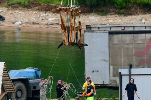 Killer whales are transported to a tank on a truck to be released from the "whale jail" earlier this year