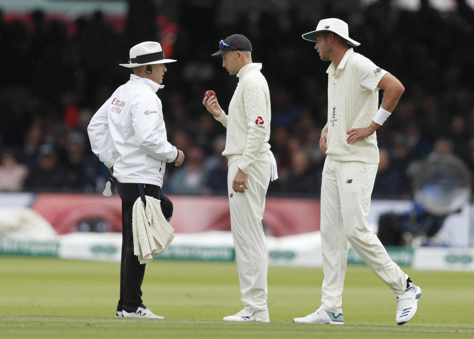 Umpire Christopher Gaffaney, left speaks to England's Joe Root, centre, and England's Stuart Broad on day three of the 2nd Ashes Test cricket match between England and Australia at Lord's cricket ground in London, Friday, Aug. 16, 2019. (AP Photo/Alastair Grant)