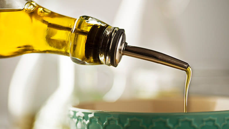 Pouring olive oil in bowl