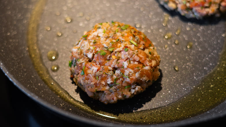 salmon burger cooking in pan 