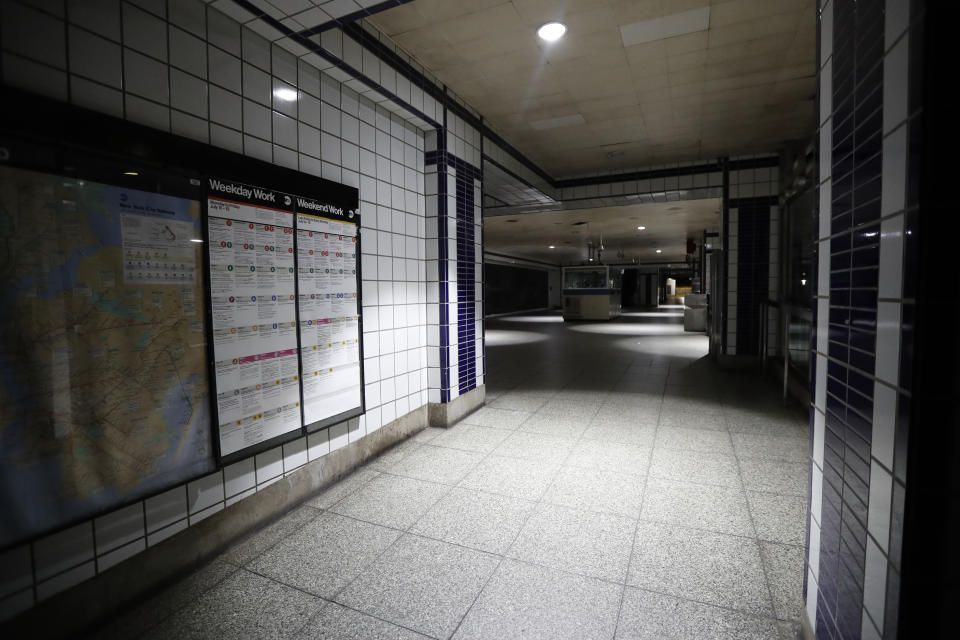 A subway station with emergency lighting is in the dark during a widespread power outage, Saturday, July 13, 2019, in New York. Authorities were scrambling to restore electricity to Manhattan following a power outage that knocked out Times Square's towering electronic screens, darkened marquees in the theater district and left businesses without electricity, elevators stuck and subway cars stalled. (AP Photo/Michael Owens)