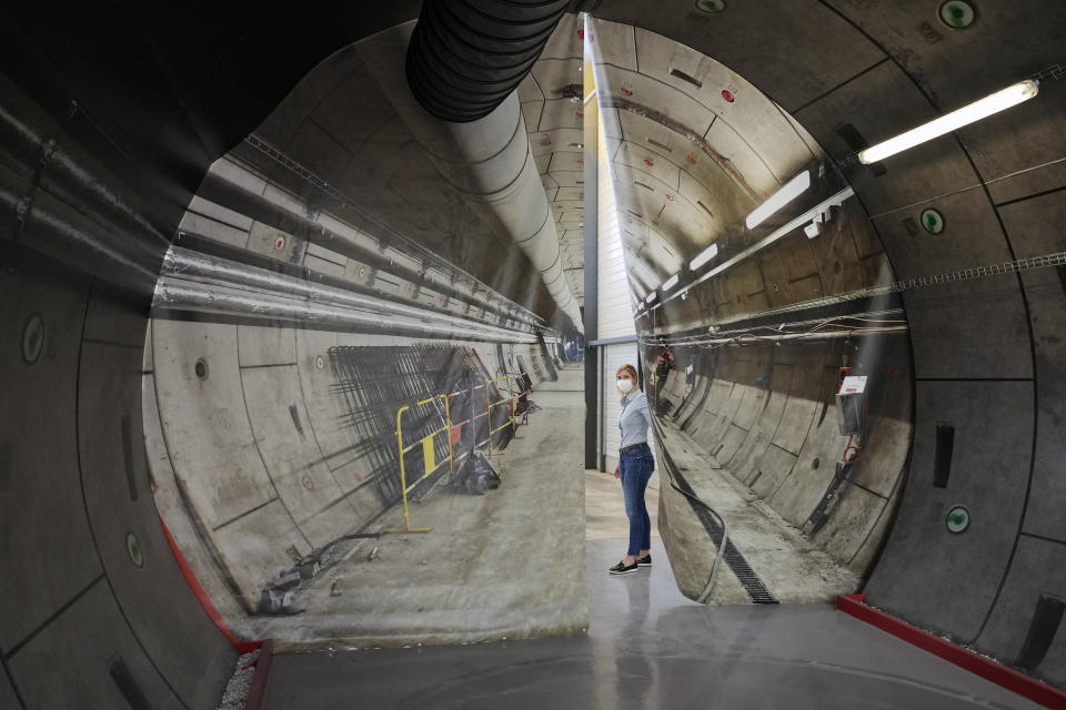 Audrey Guillemenet, geologist and spokesperson, shows a tunnel project map for radioactive waste in an underground laboratory run by French radioactive waste management agency Andra, in Bure, eastern France, Thursday, Oct. 28, 2021. Nuclear power is a central sticking point as negotiators plot out the world’s future energy strategy at the climate talks in Glasgow, Scotland. (AP Photo/Francois Mori)