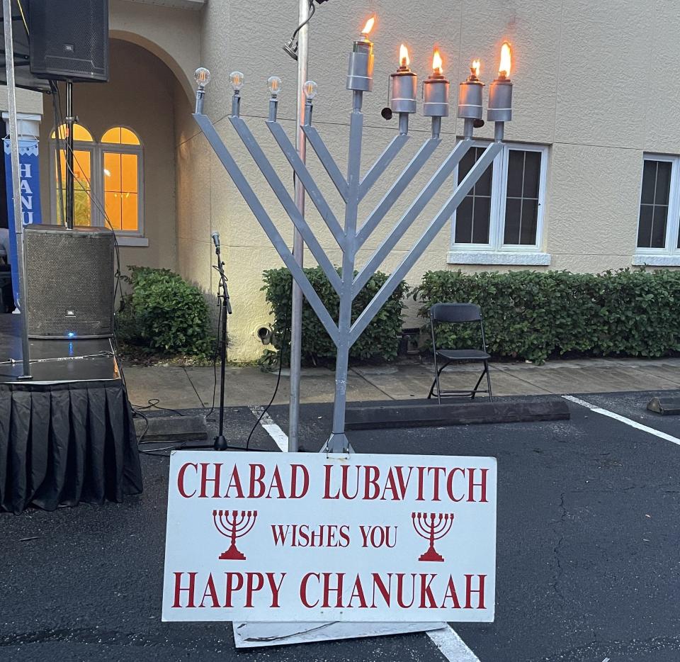 Four wicks of the menorah are lit Sunday at a Hanukkah celebration at the Chabad Lubavitch of Greater Daytona Beach in Ormond Beach, signifying the fourth day. The holiday runs eight days.