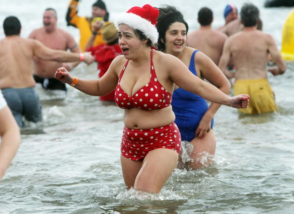 NEW YORK, NY - JANUARY 1: A woman reacts to the frigid water during the Coney Island Polar Bear Club's New Year's Day swim on January 1, 2013 in the Coney Island neighborhood of the Brooklyn borough of New York City. The annual event attracts hundreds who brave the icy Atlantic waters and temperatures in the upper 30's as a way to celebrate the first day of the new year. (Photo by Monika Graff/Getty Images)