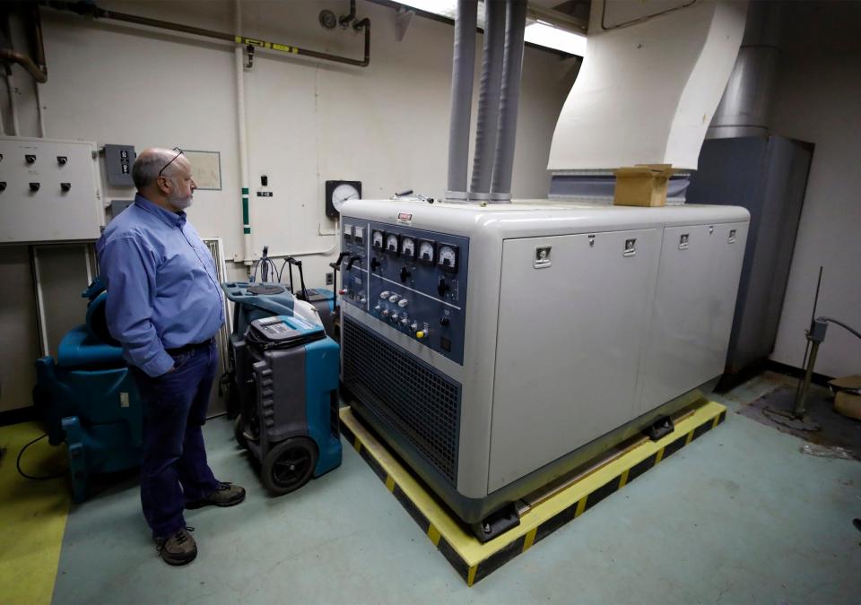 William Martin shows visitors a generator in the Cold War-era bunker under the property he is selling near Hilliard.