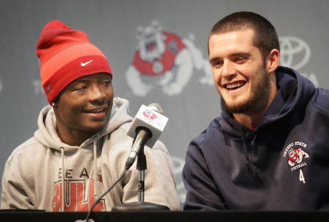 Robbie Rouse, left, and Derek Carr speak at a Hawaii Bowl news conference at Fresno State in December 2012. “Derek is a competitor. He’s a gamer,” Rouse says.