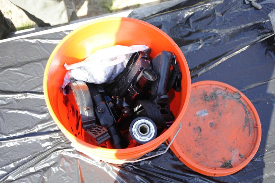 A Home Depot bucket filled with weapons and tools recovered from the Blake Falls Reservoir in Adirondack Park in Parishville, New York. The FBI believes Keyes buried caches like this throughout the U.S. If a member of the public finds one, the FBI says so  to not touch it. Call the FBI at 1-800-CALL-FBI or visit https://www.fbi.gov/tips. / Credit: FBI