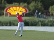 Mar 30, 2017; Humble, TX, USA; Rickie Fowler hits his approach on the 18th hole during the first round of the Shell Houston Open at Golf Club of Houston - The Tournament Course. Erich Schlegel-USA TODAY Sports