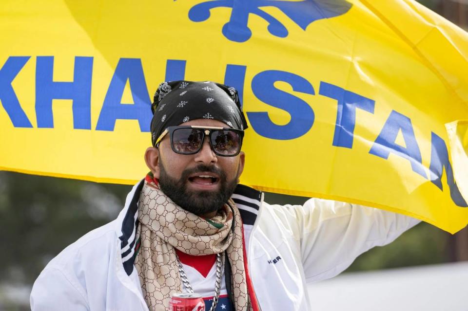 Bakersfield resident Nirmal Singh stands in front of a Khalistan flag at the Yuba City Nagar Kirtan Sikh parade. The flag is a symbol of the separatist movement that calls for the creation of Sikh country in the Punjab region of India.