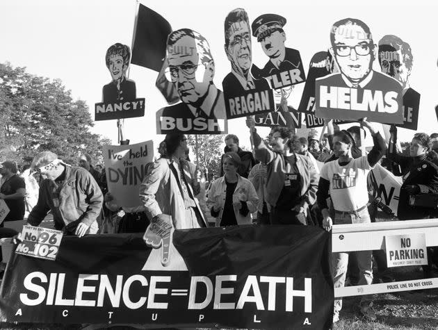 In 1988, members of the AIDS activist group ACT UP (AIDS Coalition to Unleash Power) hold up signs of Nancy Reagan, Ronald Reagan and others with the word 