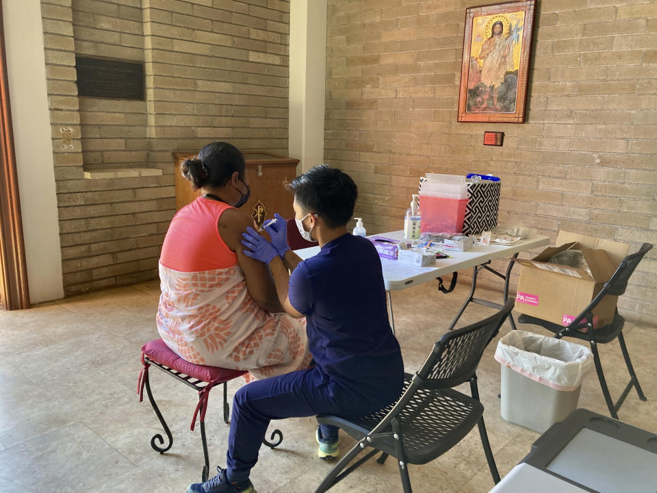 Lara Geyrozaga, a nurse with Project Vision Hawaii, administers a COVID-19 vaccine dose to Eileen Pelep at a vaccination clinic in Honolulu, on Wednesday, July 14, 2021. The pandemic has underscored the importance of collecting and reporting racial data. Honolulu City Councilwoman Esther Kiaʻāina says the pandemic's toll on Pacific Islanders who are not Native Hawaiian inspired her to introduce a resolution urging Hawaii government agencies to collect more specific data about Pacific Islanders. (AP Photo/Jennifer Since Kelleher)