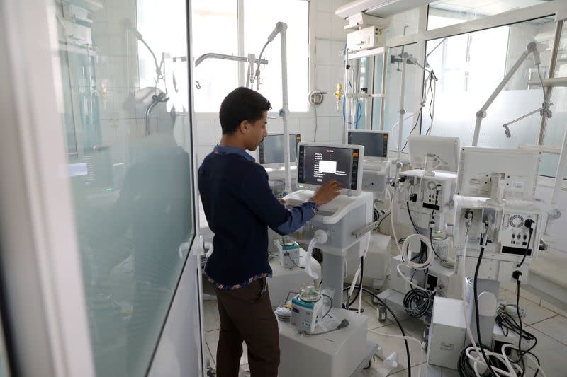 A worker sets up a ventilator recently provided by the World Health Organization at the intensive care ward of a hospital allocated for coronavirus patients in preparation for any possible spread of the coronavirus disease (COVID-19), in Sanaa