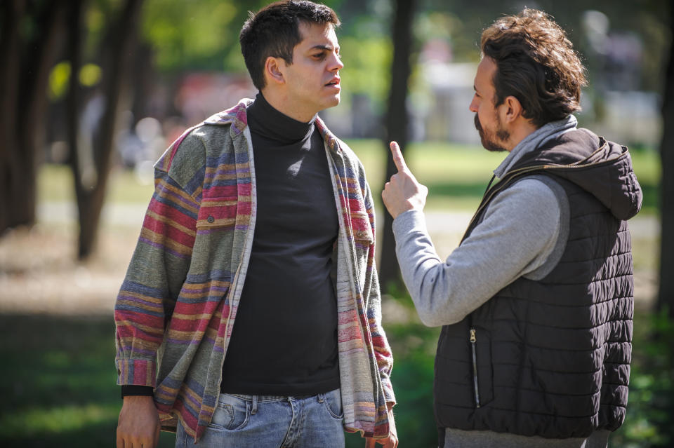 two men talking outside