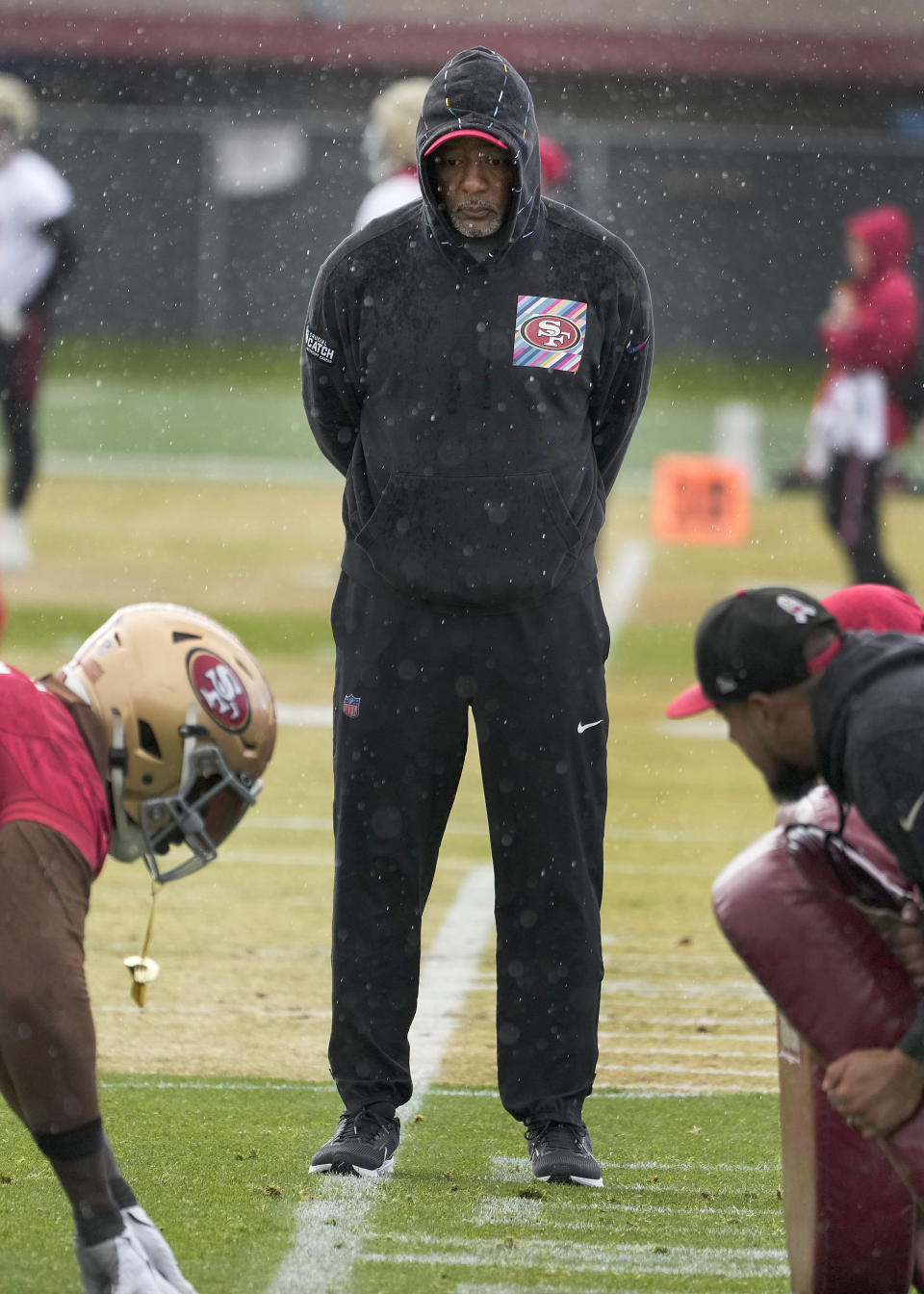 San Francisco 49ers defensive coordinator Steve Wilks, center, watch as players practice at the team's NFL football training facility in Santa Clara, Calif., Friday, Feb. 2, 2024. The 49ers will face the Kansas City Chiefs in Super Bowl 58. (AP Photo/Tony Avelar)