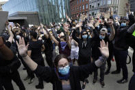 Protesters demonstrate in Boston, Sunday, May 31, 2020, over the death of George Floyd who died after being restrained by Minneapolis police officers on May 25. (AP Photo/Steven Senne)