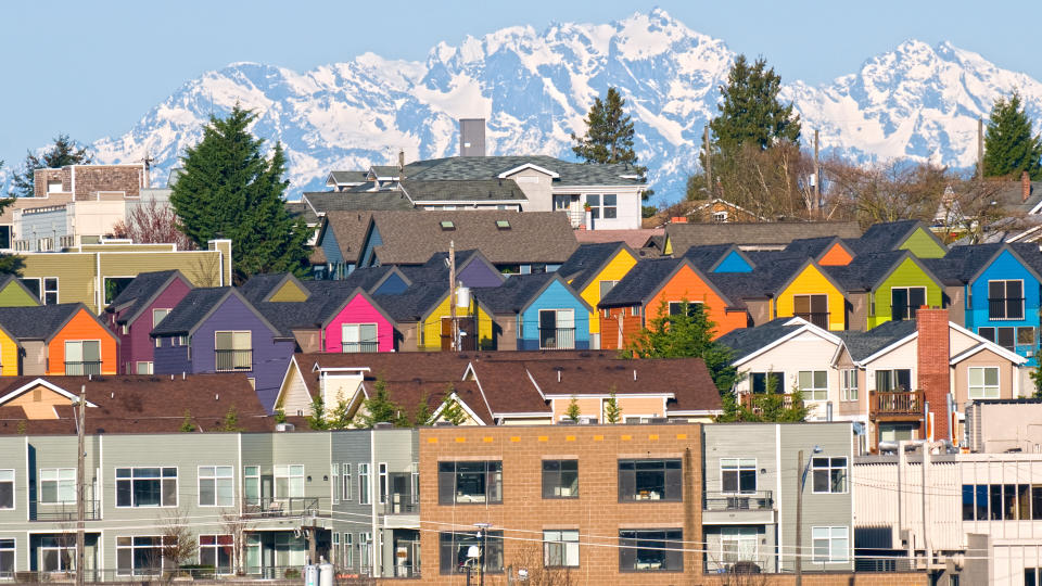 Row of colorful townhouses and Olympic Mountain range from Seattle WA.