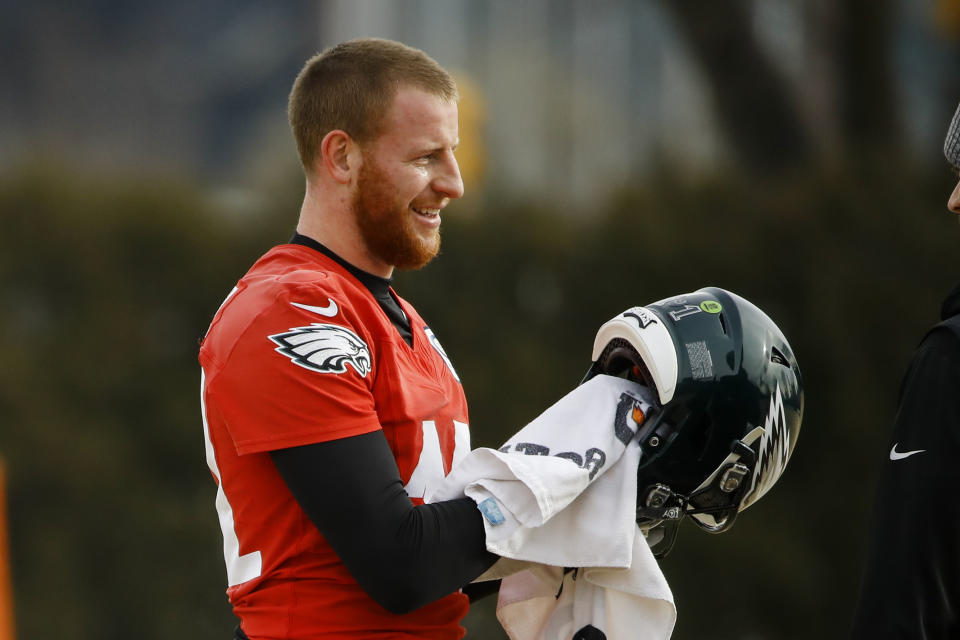 Philadelphia Eagles quarterback Carson Wentz wipes down his helmet at the NFL football team's practice facility in Philadelphia, Thursday, Jan. 2, 2020. The Seattle Seahawks travel to Philadelphia to play the Eagles in an NFC wild-card matchup on Sunday. (AP Photo/Matt Rourke)