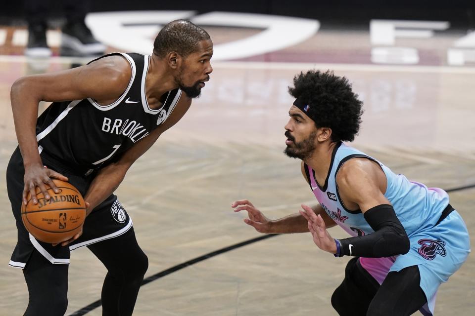 Miami Heat's Gabe Vincent (2) defends against Brooklyn Nets' Kevin Durant (7) during the second half of an NBA basketball game Saturday, Jan. 23, 2021, in New York. (AP Photo/Frank Franklin II)