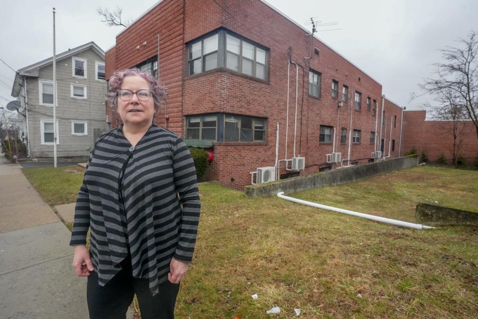 Lisa Peterson, of the addiction treatment center VICTA, stands outside the Pawtucket site of Safe Landings, a new short-term residential program for people who relapse during treatment for substance-use disorder.