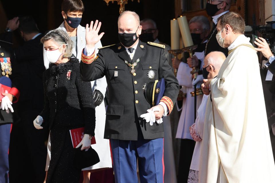 Prince Albert II of Monaco, Princess Gabriella and Prince Jacques stand with a message for Princess Charlene at the balcony of Monaco Palace