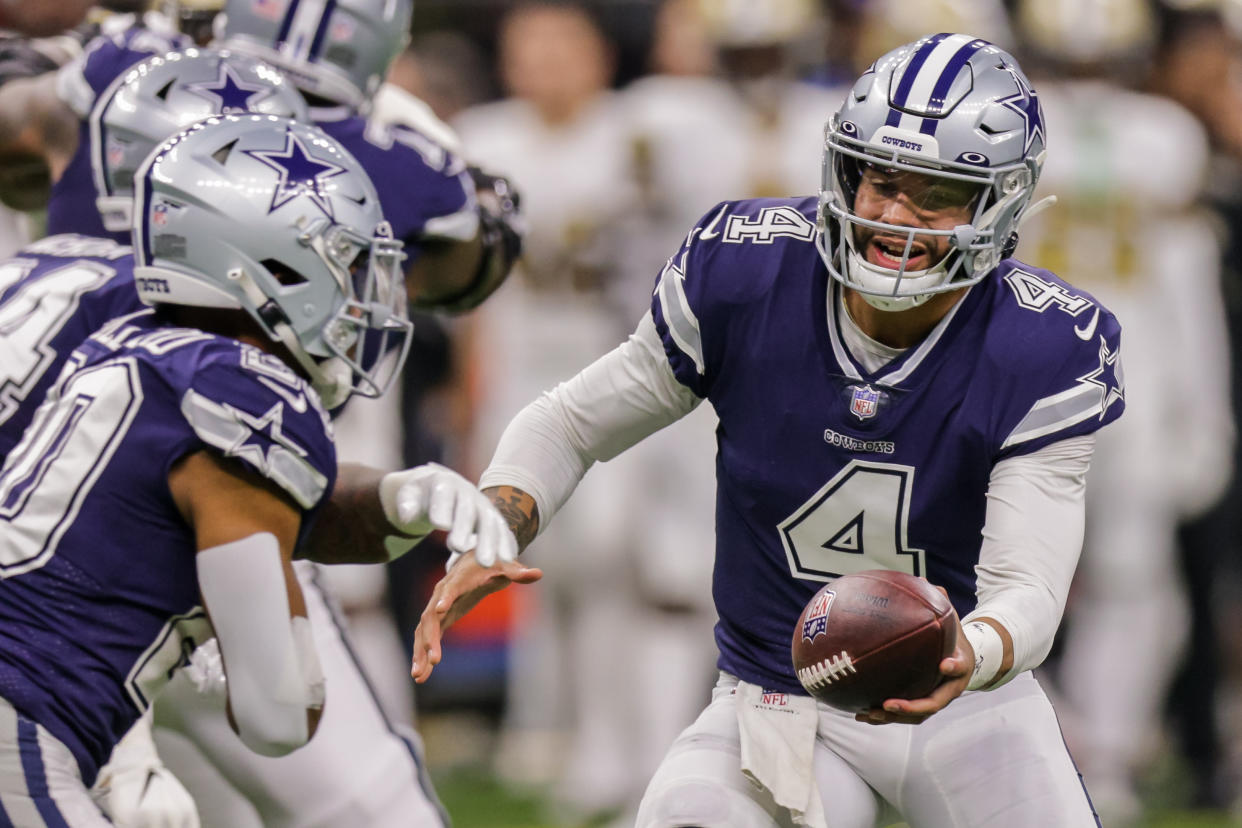 Dec 2, 2021; New Orleans, Louisiana, USA; Dallas Cowboys quarterback Dak Prescott (4) hands the ball off against New Orleans Saints during the first half  at Caesars Superdome. Mandatory Credit: Stephen Lew-USA TODAY Sports