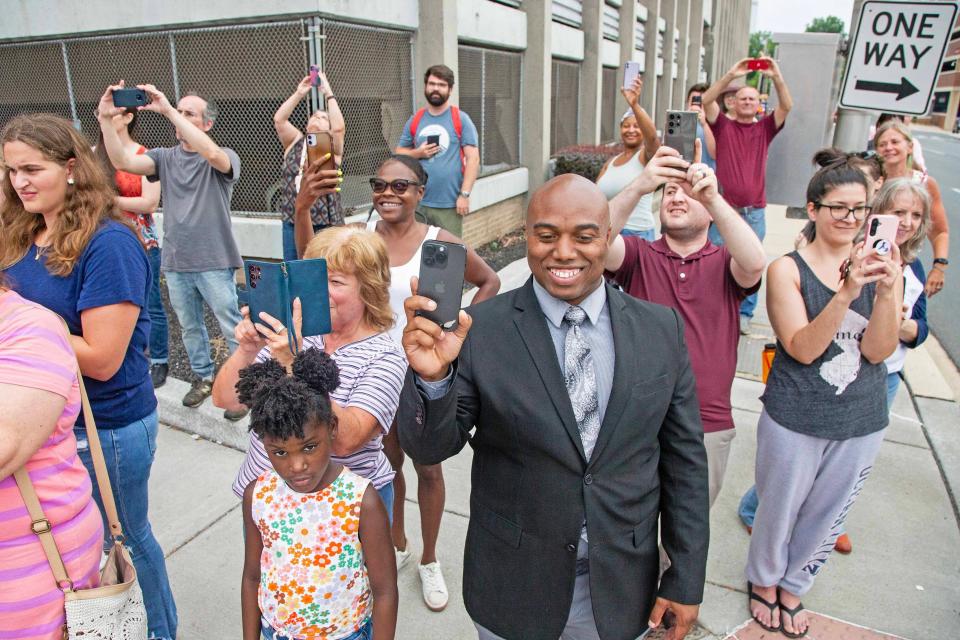 Community members, some of whom waited upwards of three hours, capture videos of Vice President Kamala Harris' motorcade at the corner of West and 12th Streets in Wilmington, Monday, July 22, 2024. Harris visited Biden campaign headquarters inside the Brandywine Building for a campaign engamement.