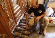 A Free Syrian Army handles homemade mortar shells inside a house in the old city of Aleppo September 10, 2013. REUTERS/Molhem Barakat