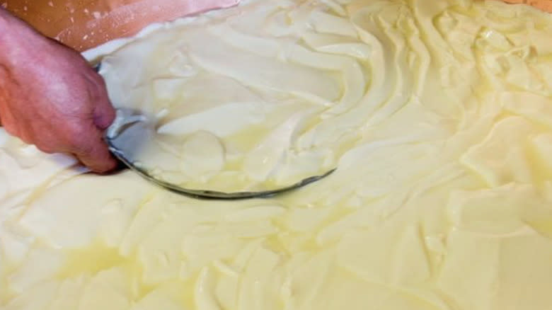 cheese makers making cheese