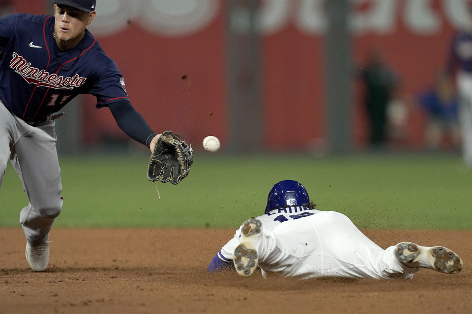 Kansas City Royals' Nate Eaton beats the tag by Minnesota Twins third baseman Gio Urshela to steal second during the fifth inning of a baseball game Tuesday, Sept. 20, 2022, in Kansas City, Mo. (AP Photo/Charlie Riedel)