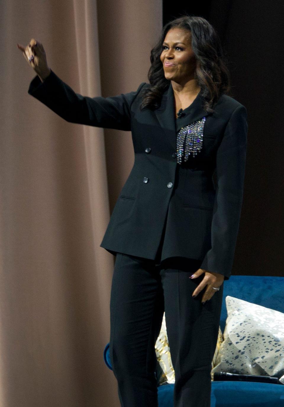 Michelle Obama wears a black pantsuit in 2018.