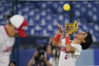 Japan's Yu Yamamoto catches a fly out during a softball game against the United States at the 2020 Summer Olympics, Tuesday, July 27, 2021, in Yokohama, Japan. (AP Photo/Sue Ogrocki)