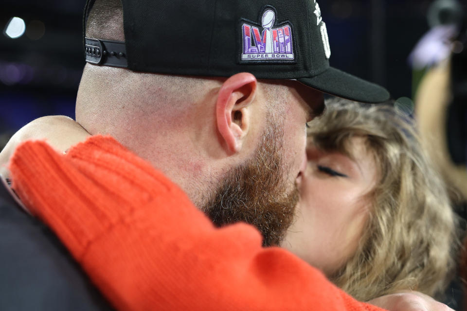 Taylor Swift and Travis Kelce on field after the Chiefs victory on January 28, 2024