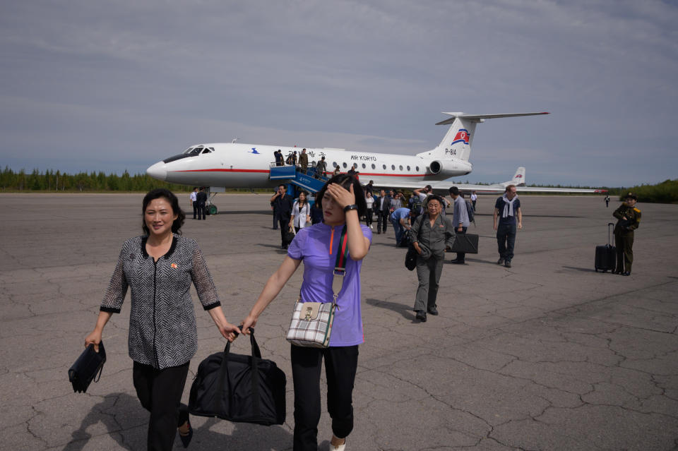 A photo taken on September 10, 2019 shows passengers disembarking from a Tupolev TU-134 aircraft upon arrival in North Korea's northern city of Samjiyon. - The monumental construction project in the far reaches of North Korea ordered by leader Kim Jong Un, involves nothing less than the rebuilding of the entire town of Samjiyon, the seat of a county which includes the supposed birthplace of Kim's father and predecessor Kim Jong Il, and Mount Paektu, the spiritual birthplace of the Korean nation. The plan includes a museum of revolutionary activities, a winter sports training complex, processing plants for blueberries and potatoes -- two of the area's most important crops -- a new railway line to Hyesan, and 10,000 apartments. (Photo by Ed JONES / AFP) / To go with NKorea-politics-economy-construction-Samjiyon, FOCUS by Sebastien Berger        (Photo credit should read ED JONES/AFP via Getty Images)